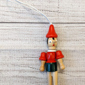 A painted, wooden ornament of Pinocchio.