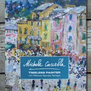 The exhibition catalogue Michele Cascella: Un Pittore Senza Tempo, the cover featuring a painting of an Italian town with colorful houses in the background and people walking in the foreground, with the title displayed at the bottom in a blue rectangular box.