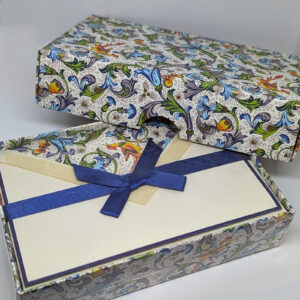 A cream-colored card set featuring a blue-hued floral design, with orange bird and butterfly accents.