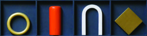 A 3D black rectangle divided into four parts. Each part contains an object: a golden ring, an orange half-vertical cylinder, a white arch, and a golden rhombus.