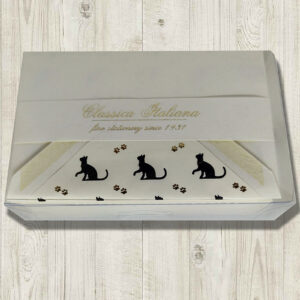 A cream-colored card set featuring a black cat and gold paw print design.