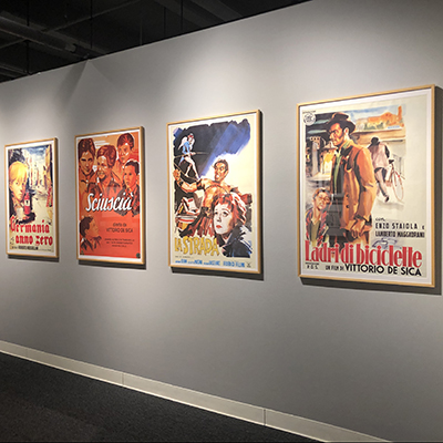 A sequence of four posters showing four Neorealismo movies: from left to right: "Germania anno zero," "Sciuscià," "La strada," and "Ladri di biciclette."