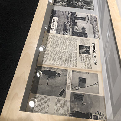 A section of a display case containing black-and-white newspapers from the Neorealism era