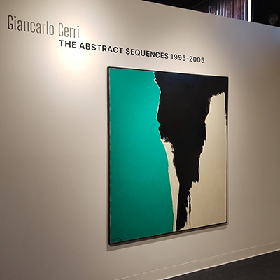 On this wall, there is the title "Giancarlo Cerri: The Abstract Sequences 1995-2005." Below the title is an abstract painting done with three colors: aqua, black, and cream.