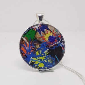 A necklace with a circular pendant, which features an abstract spash of colors and a small butterfly.