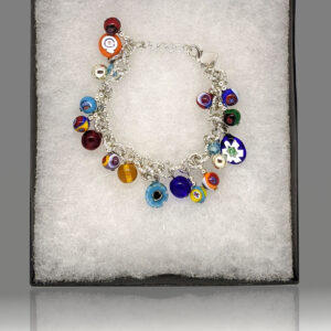 A silver charm bracelet featuring multicolored millefiori handblown glass charms.