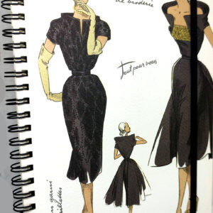 A spiral notebook with a cover featuring fashion sketches, held closed by a black elastic band.