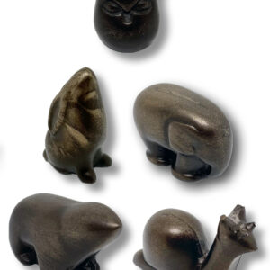 A stylized bronze statuette of an owl. // A stylized bronze statuette of a bear.