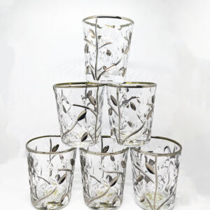 A set of 6 glass shot glasses, stacked in a pyramid. Each shot glass features a silver rim, and a silver branch and petal design.