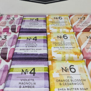 A square-shaped soap, with orange-hued packaging featuring an abstract design and labeled "No. 7" with additional information.