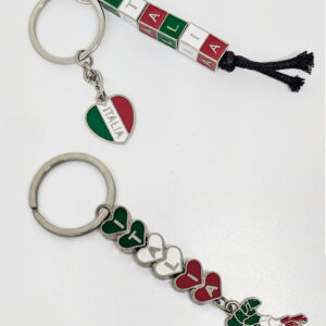 A silver keychain with green, white, and red heart-shaped charms spelling out "Italia", with a charm of Italy on the end. // A silver keychain with green, white, and red block-shaped charms spelling out "Italia", with a heart-shaped charm with "Italia".