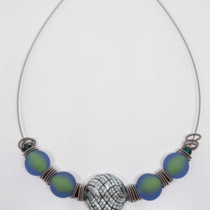 A necklace with sage green glass beads, iridescent green-blue glass beads, and silver spacer rings on a metal cord.