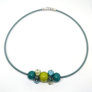 A necklace with a cluster of teal, lime, and earth-toned spherical glass beads on a teal metal cord.