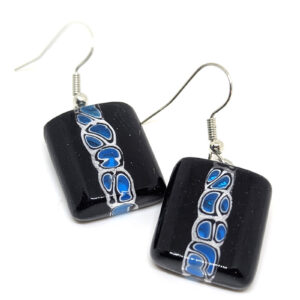 A pair of glass dangle earrings, featuring a black, white, and blue abstract bubble pattern down the center.