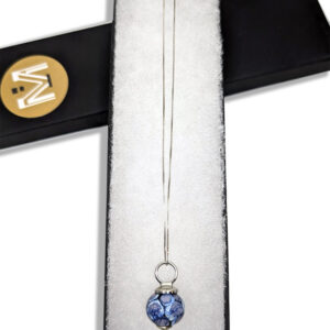 A necklace featuring a blue-hued glass bead pendant on a sterling silver chain.
