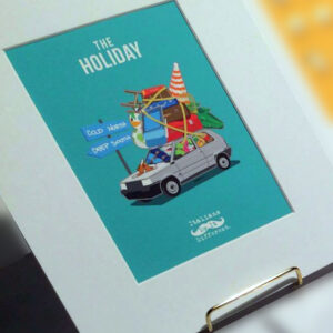 A print featuring an illustration of a white car, overloaded with vacation items both inside and strapped to the roof, and two street signs pointed in opposite directions. The title "The Holiday" is in white text.