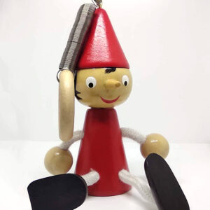 Wooden Pinocchio toy in a painted red, with a spring on top.