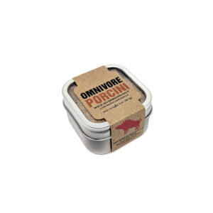 A small, metallic tin of salt, wrapped in a brown paper sleeve with "OMNIVORE PORCINI".