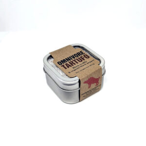 A small, metallic tin of salt, wrapped in a brown paper sleeve with "OMNIVORE TARTUFO".