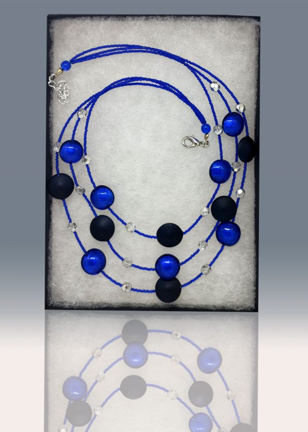 A three-tiered necklace made of gorgeous black beads peppered and fused with fragments of blue glass.